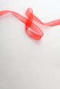 Red tulle ribbon on top on white background isolated Royalty Free Stock Photo