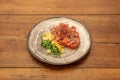 Red tuna and watermelon tartare with sesame and poppy seeds. Grated carrot, wakame salad, chopped mango and saffron filaments on Royalty Free Stock Photo