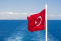 Red Turkish flag and keel water, trace on surface of sea in Mediterranean. Royalty Free Stock Photo