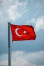 Red Turkish flag waving in the wind and blue sky in the background Royalty Free Stock Photo