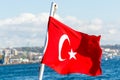 Red Turkish National flag on a cruise ship sailing on  the Bosphorus strait, Istanbul,Turkey Royalty Free Stock Photo