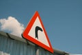 Red turn right street sign with blue sky and clouds Royalty Free Stock Photo