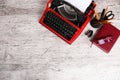 Red typewriter on the table with the office. Royalty Free Stock Photo