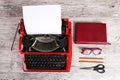 Red typewriter on the table with the office. Royalty Free Stock Photo
