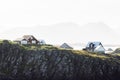 Red typical Icelandic wooden houses on the edge of a cliff near sea - Stykkisholmur