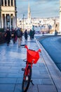 Red Uber bike with Brussels` Mont des arts behind it
