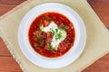 Red Ukrainian borscht in bowl on rustic table, top view Royalty Free Stock Photo