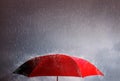 Red umbrella against the storm, sky background and black cloud group and rain, thunderstorm with savings and investment, life and