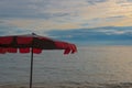 Red Umbrella on the beach and Beautiful sunset and sky of the sea. Royalty Free Stock Photo