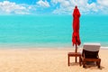 Red umbrella, deck chair, solar parasol, sun lounger, chaise lounge, sun bed, tropical island sea beach, summer holidays, vacation Royalty Free Stock Photo