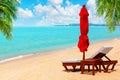 Red umbrella, deck chair, parasol, sun lounger, chaise lounge, sun bed, palm, tropical island sea beach, summer holidays, vacation Royalty Free Stock Photo