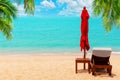 Red umbrella, deck chair, parasol, sun lounger, chaise lounge, sun bed, palm, tropical island sea beach, summer holidays, vacation Royalty Free Stock Photo