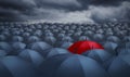 Red umbrella outstanding from the others Royalty Free Stock Photo