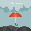 Red umbrella in rainy day with black umbrella and cloudy sky Royalty Free Stock Photo