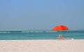 Red umbrella on a sand beach at seaside Royalty Free Stock Photo