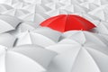 Red umbrella standing out from the crowd of white umbrellas Royalty Free Stock Photo