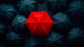 A red umbrella surrounded by many blue umbrellas in the dark Royalty Free Stock Photo