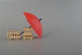 Red umbrella and toy vehicles. Vehicle insurance, warranty, repair, financial, banking and money concept