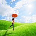 Red umbrella woman in grassland and sun sky