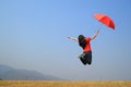 Red umbrella woman jump to Blue sky Royalty Free Stock Photo