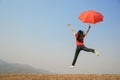 Red umbrella woman jump to Blue sky Royalty Free Stock Photo