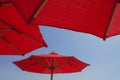 Red Umbrellas On Blue Sky Background