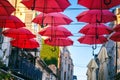 Red umbrellas over street in european city, urban festive background and texture Royalty Free Stock Photo