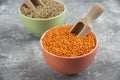Red uncooked lentils and split peas in colorful bowls Royalty Free Stock Photo