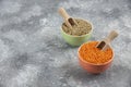 Red uncooked lentils and split peas in colorful bowls Royalty Free Stock Photo