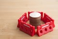 Red under construction barrier around stacked coins with copy space. Global world economy crisis, repair, fix, revise or reset Royalty Free Stock Photo