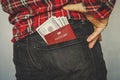 red passport in a pocket of jeans