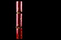 Single Red Christmas Cracker Upright on a Black Background Royalty Free Stock Photo