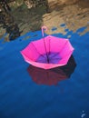 Red upturned umbrella floating on water surface Royalty Free Stock Photo