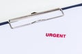 Red urgent stamp on white paper with clipboard Royalty Free Stock Photo
