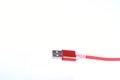 Red USB cable for smartphone charge isolated on white background Royalty Free Stock Photo