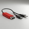 A red USB drive with a standard USB-A connector is positioned next to a black cable Royalty Free Stock Photo