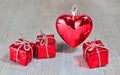 Red valentine or christmas heart and gifts on white wooden background