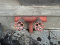 Red valve handles from a fire hydrant built into a residential building Royalty Free Stock Photo