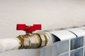 Red valve on the heating pipe. Close-up, selective focus Royalty Free Stock Photo
