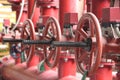 Red valves on metal pipe. Valve is a device that regulates, directs or controls the flow of a fluid like gases, liquids by opening Royalty Free Stock Photo