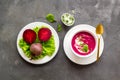 Red vegetarian beet root soup with sour cream and raw beets Royalty Free Stock Photo