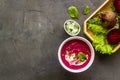 Red vegetarian beet root soup with sour cream and raw beets Royalty Free Stock Photo