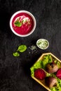 Red vegetarian beet root soup with sour cream and raw beets Royalty Free Stock Photo