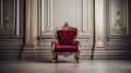Red velvet armchair in a luxurious room with white paneled walls and gold accents Royalty Free Stock Photo