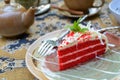 Red velvet cake with cup of tea and kettle Royalty Free Stock Photo