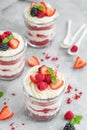 Red Velvet cake trifle with fresh berries in a glass jar on a gray concrete background. Dessert for Valentine`s Day. Copy space Royalty Free Stock Photo