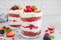 Red Velvet cake trifle with fresh berries in a glass jar on a gray concrete background. Dessert for Valentine`s Day. Copy space Royalty Free Stock Photo