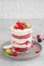 Red Velvet cake trifle with fresh berries in a glass jar on a gray concrete background. Dessert for Valentine`s Day. Copy space Royalty Free Stock Photo