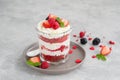 Red Velvet cake trifle with fresh berries in a glass jar on a gray concrete background. Dessert for Valentine`s Day. Copy space Royalty Free Stock Photo