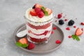 Red Velvet cake trifle with fresh berries in a glass jar on a gray concrete background. Dessert for Valentine`s Day. Copy space Royalty Free Stock Photo